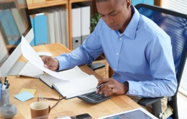 high-angle-view-male-accountant-checking-financial-document high-angle-view-male-accountant-checking-financial-document